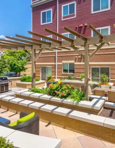 The Space Features A Pergola, Built-In Seating, Outdoor Grills & Planters